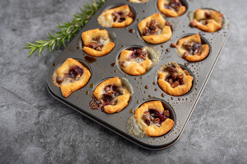 Brie bites with jam and nuts in crescent dough, mini appetizer dessert with cranberry or any jelly