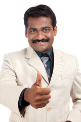 Indian business man showing thumbs up on white.