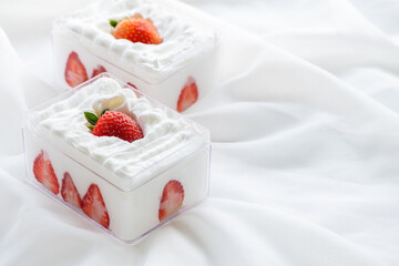 strawberry shortcake in plastic box on with cloth background and copy space,