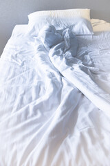 Bed and white sheets wrinkled