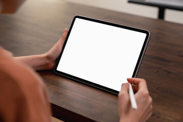 Mock up of woman hand holding digital tablet and touching blank screen.