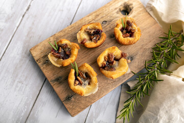 Brie bites with jam and nuts in crescent dough, mini appetizer dessert with cranberry or any jelly