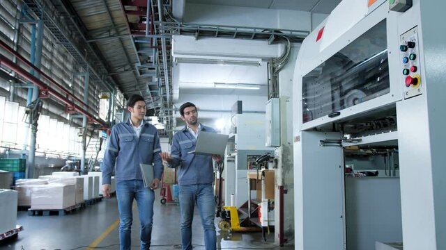 specialist worker engineer team control and operate printing package lable machine with computer screen with concentrate and focus industrial factory machinery ideas concept