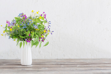 summer wild flowers in vase on white background