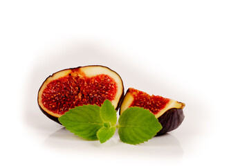 sliced ripe sweet fig fruits and mint leaves isolated on white background