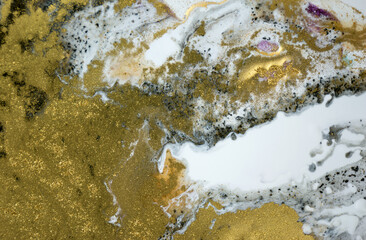 Golden dust background on white paint background. Sparkling gold texture.