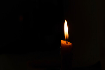 A burning candle in the night