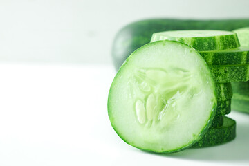 Fresh cucumber slices on white background.