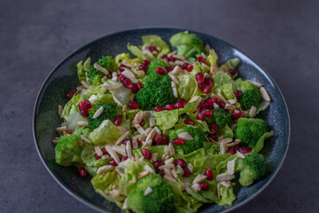 healthy tasty Broccoli salad with pomegranate on a table