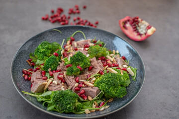 healthy tasty Broccoli salad with pomegranate on a table