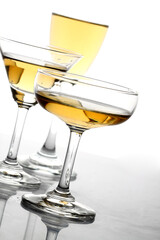Glasses of alcohol drinks on white.