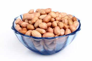 Bowl of peanuts on white.