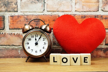 Happy Valentines Day with Love alphabet letter with alarm clock and red heart decoration on brick wall background