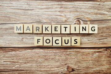 Marketing Focus alphabet letter on wooden background