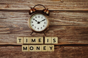 Time Is Money Word alphabet letters on wooden background