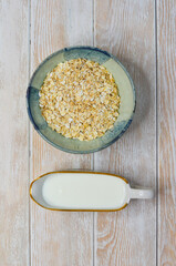 Minimalism in food, ingredients for a healthy breakfast, oatmeal and milk