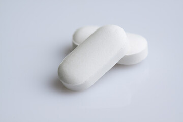 white pills on white background