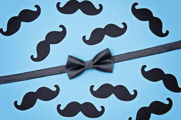 Father's day card background on blue background. Composition of a tie, bow tie, mustache. Father's day holiday concept.