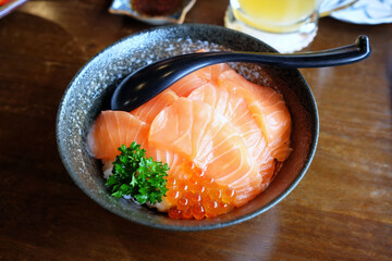 Salmon Sashimi Bowl or Fresh Sashimi Strips over Rice that is a Famous Japanese Recipe.