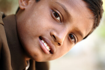 Indian teen boy smiling.