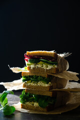 Vegetarian sandwich with fresh cucumber, avocado and corn salad leaves