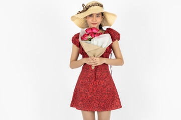 Love and romance on Valentines day. Beauty young Asian woman in red dress holding bouquet of roses over white isolated background.