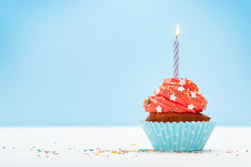 Birthday cupcake with burning candle