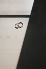 Rings just married on a table with a shadow