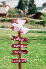 Wooden track pointer on the road in sunny summer day