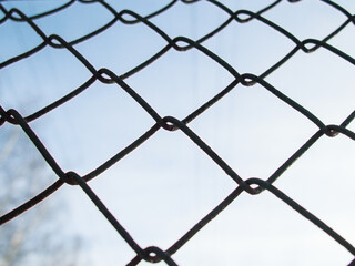Fototapeta premium Chain-link. Fence against the sky.