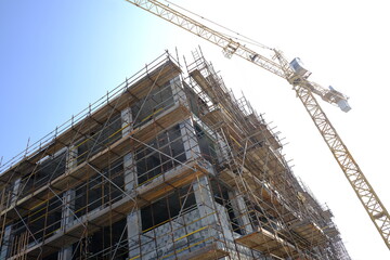 building under construction with tower crane
