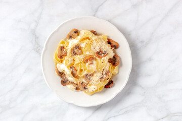 Pappardelle pasta with mushrooms, cream sauce and grated Parmesan cheese, top shot