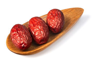dried red dates in the wooden plate, isolated on the white background