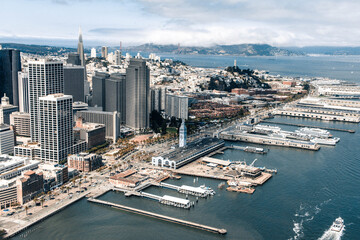 Aerial shot of San Francisco along the Bay with boats, buildings, and clouds © Alec
