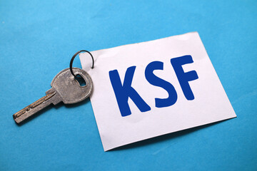 KSF key success factor, text words typography written on paper against blue background, life and business motivational inspirational