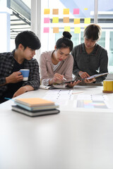 Group of creative designer at the meeting table for discussing the important issues of the new successful startup project.