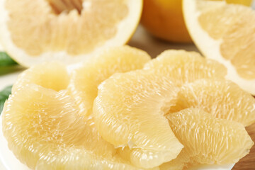 Ripe pomelo fruit slices, close up and space for text