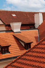 Shingles.Tiled roof.The roof is made of corrugated sheet of red, orange color. The roof is made of a wavy profile.
