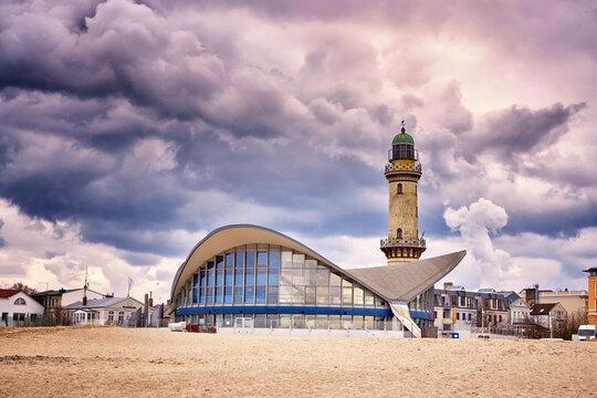 Teepott and lighthouse under dramatic clouds in Warnem&uuml;nde.