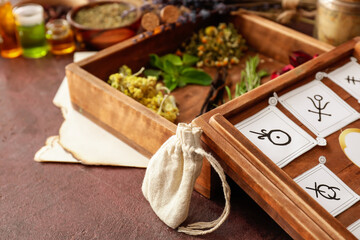 Alchemical symbols and ingredients for preparing potions on color background