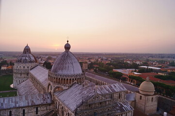Fototapeta premium View of the cathedral and baptistery of Pisa from the leaning tower at sunset, Tuscany, Italy