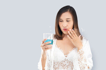 Asian woman feels a burn in her mouth because of the alcohol in the mouthwash