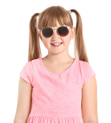 Naklejka premium Cute little girl wearing stylish sunglasses against white background