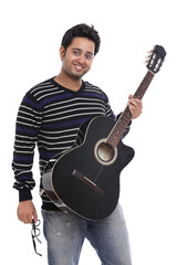An Indian guitar player posing with guitar on white background.