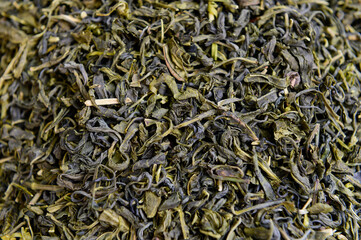 Dried green tea leafs background