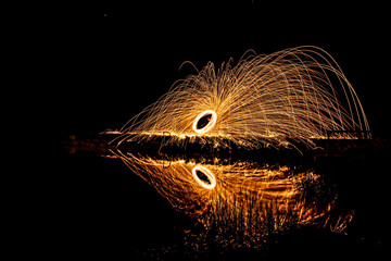 light painting  over water with reflections