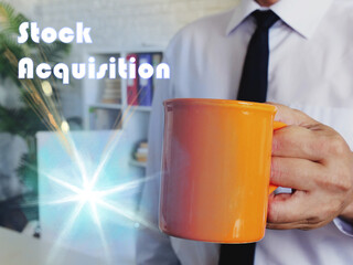 Business concept meaning Stock Acquisition with Man with a cup of coffee in the background.