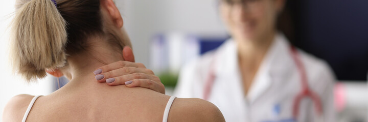 Woman complains of neck pain to doctor. Pain in the cervical spine concept