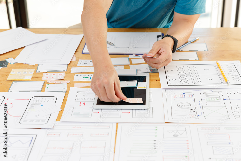 Wall mural graphic designers work together with ux ui designer planning application template layout framework f