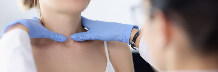 Doctor examines the patient's thyroid gland. Examination of the thyroid gland concept